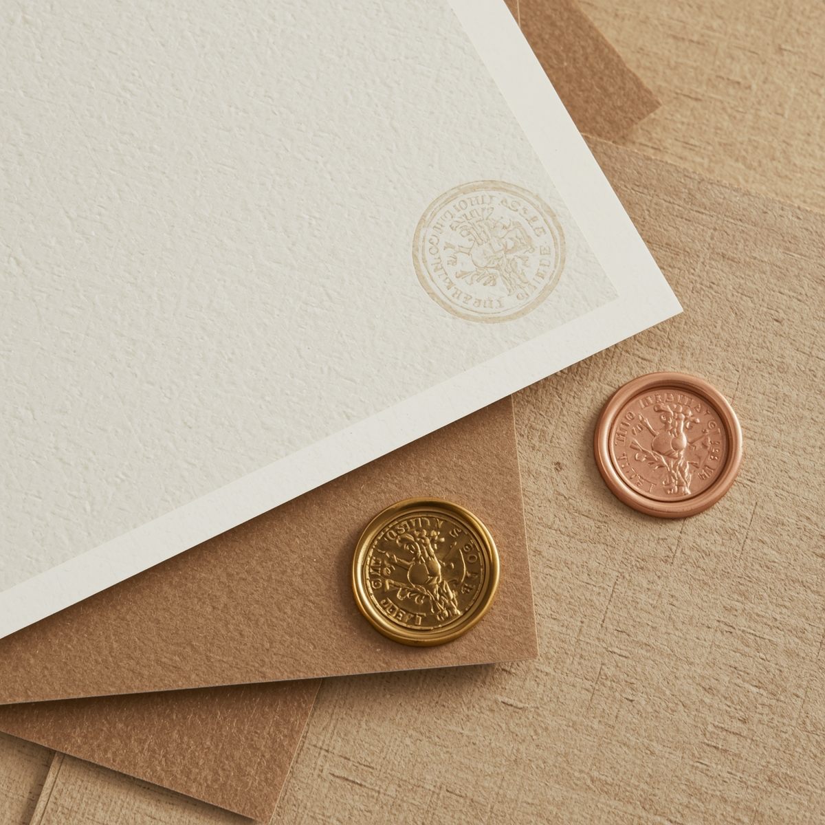Stack of textured handmade paper sheets in various warm tones showing natural fiber patterns